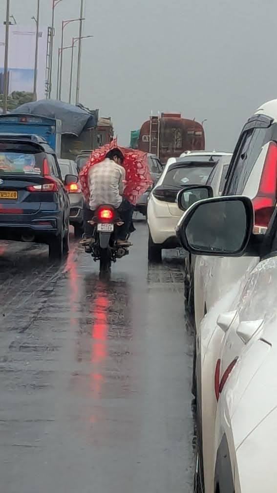 An umbrella lashed to a bike in the rain
