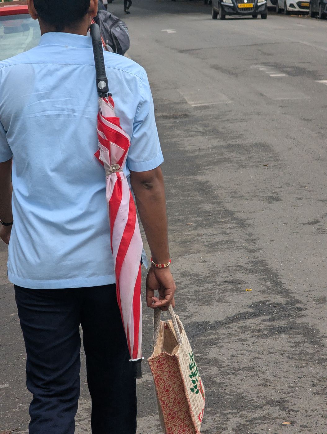 An umbrella hooked as a carry strap
