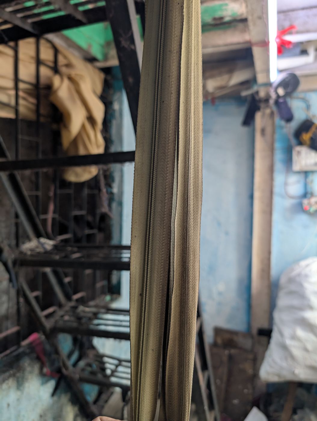 A zip-strap hung down steep stairs as a handrail